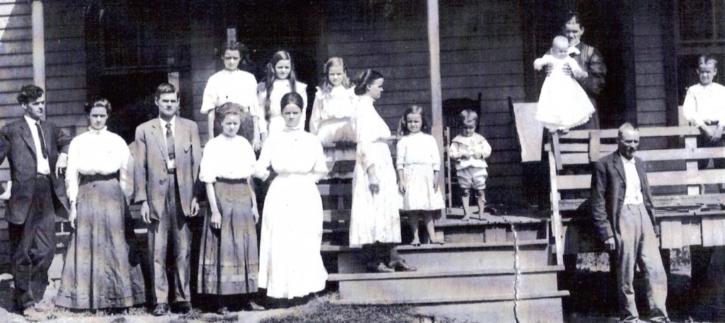 Childen pictured left to right: (front row): Rufus, Annie, George, Emma, Ella; (back row): Bird, Mary, Mamie. Girl standing sideways is Ada, small girl in center is Fannie, small boy in center is Clyde, and boy standing at far right is Bill. Baby is Lela, mother is Martha, and father is James.