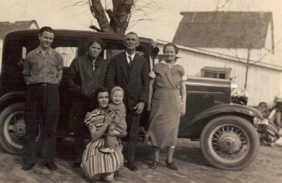 (In front): Ruth Merrick in dress, and George Merrick, son of George Merrick in Hine photo. (Standing L-R): Wallace Merrick, 7th child of Edward and Lillie; Lutisia Merrick, wife of George Merrick; Edward Merrick and Lillie Merrick. Photo taken about 1940. 
