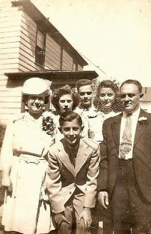 1944 photo provided by family. Boy in front is Harold Basch (son in the interview). Back row (L-R): Dora Nevins, children Gloria, Herbert and Bernice, and husband Frank on the right.