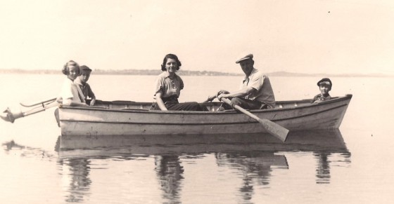 Grayson Forsyth (rowing) with (L-R): daughter Dorothy, son Grayson, wife Mary, and son Richard. In the background is the Franklin Roosevelt cottage on Campobello Island. Photo taken in 1939.