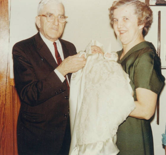 as described by Monica Sharpe: "Michael is with my mother Mary Devine Becotte, and my son Eric, in October of 1966. Eric is wearing my reworked wedding gown at his Christening, as did our other two sons and all our grandchildren." 