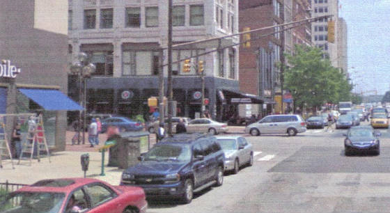 John would have been standing to left of gray car that is behind blue station wagon.